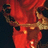 A pixelated image with red text on black background and a red-toned character illustration on the left.