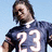 Pixelated image of a person in a dark blue jersey with white number 23, standing against light blue background, next to red with text