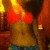 A pixelated static image shows a figure with red hair and a yellow top against warm-toned background elements.