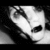 Pixelated grayscale image of a stylized mask with two eye openings and a curved nose bridge, set against a dark background.