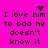 A bright pink background displays repeated text "I love him to bad he doesn't know it" with a black heart symbol above the first line and a pixelated starburst effect in the top-right corner.