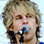 A 2x2 contact sheet of a pixelated animated icon featuring a blonde male singer with microphone, showing three distinct frames including text and heart symbol variations.