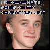 Pixelated image of a person with short light hair and blue eyes, wearing dark clothing against a dark background.