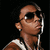 Pixelated image of a person wearing sunglasses, a sleeveless shirt, and earphones, with a black background.