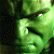 A 50x50 pixel animated contact sheet showing two frames of a green-skinned character with clenched fists and visible teeth, displayed side-by-side on a gray transparency background.