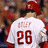 Pixelated image of a person wearing a white baseball jersey with red text and number 26, viewed from behind.