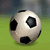 Pixelated soccer ball with black pentagons on white surface, resting on green grass background under gray sky.