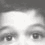 Black-and-white pixelated image of a child's face divided into four quadrants with varying brightness levels.