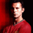 Pixelated static image of a person in profile wearing red clothing against dark and red background.