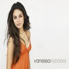 A woman with long dark hair wears an orange sleeveless dress against a plain white background, with text visible at the bottom right.