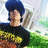 Pixelated image of a person with dark blue hair wearing black shirt, holding an object near face against green and white background.