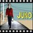 Static 48x48 pixel buddy icon with filmstrip border, featuring a person in red top and dark pants walking on beach path toward yellow text "JIM" against blue sky background.