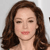 A static pixelated image of a person with long brown hair, closed eyes, and pink lips against a light gray background.
