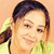 Static pixelated image of a person with light brown hair tied in a ponytail, wearing a yellow top against an orange background.