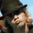 Animated sequence showing a person in a dark hat and green jacket with blonde hair, followed by a winged 'TOWN DOG' emblem on cloudy background then white background.