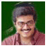 Static image of a person with short dark hair wearing a red shirt against a green background.