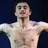 Pixelated image of a shirtless person with arms outstretched against dark background, surrounded by pixelated text in pink and white.
