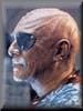 Three pixelated character portraits in a : a bald man with sunglasses, a man with dark hair, and a bearded man with a long beard