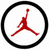 Red silhouette of a basketball player in mid-air jump shot pose enclosed within a thick black circular border on white background.