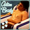 A shirtless man reclines on a striped chair with text "Adam Body" and heart symbols in the corner.