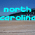 Pixelated beach scene with blue sky, wooden pier structure, and turquoise text reading 'north carolina topsail island where we come!' across four