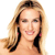 Pixelated image of a person with long blonde hair, dark roots, and pink earrings, smiling with visible teeth against a white background.