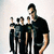 A pixelated image shows a group of stylized figures on the left and text on the right against dark background.