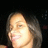 Pixelated close-up of a person's face with light skin, closed eyes, and visible mouth against dark background.