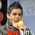 A person in a gray jacket holds a yellow object near their face, with red text reading 'Love' and partial white text below it against a blue background.