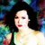 Woman with dark hair in green sleeveless top against colorful abstract background, two distinct poses visible.
