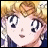 Pixelated anime-style character with blonde hair and large eyes, next to stylized text on a black background.