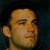 A pixelated image of a person with dark hair against a dark background, next to green text reading 'Original Icons .com' on a solid green backdrop.