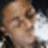 Pixelated close-up of a person's face with light skin tone, brown hair, and closed eyes, set against a dark background with a bright light source on the right.