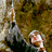 Pixelated static icon showing two figures in a dimly lit environment with muted earth tones and visible dithering patterns.
