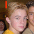 A pixelated image of two people in a group photo with red text and symbols changing across frames.