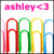 Pixelated image with pink text 'ashley<3' at top and four colored paperclips (red, green, yellow, blue) below on white background.