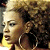 A pixelated buddy icon featuring a person with curly hair and large hoop earrings on the left, next to green text reading "Original Icons .com" on a dark background.