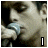 A 4-frame contact sheet of a pixelated animated icon featuring a person singing into a microphone with text overlays "I", "walk", and "alone" across frames, arranged in a 2x2 grid on a gray background.