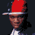 A 2x2 contact sheet of four pixelated frames showing a person in various poses and backgrounds, including wearing a red cap with white trim and a white tank top.
