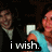 A pixelated image of two people in formal attire with a text overlay reading 'i wish.' on the left side.
