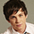 A pixelated image of a person with short brown hair wearing a white shirt, with text elements reading 'love', 'Logan', and 'Lerman!' in bold black-and-white lettering.