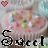 pink-frosted cupcakes with colorful sprinkles, each topped with a small red heart and the word 'Sweet' in black pixelated text