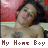 A shirtless person with dark hair and a chest tattoo lies against a red background, with text reading "My Home Boy" in pixelated brown letters below.