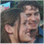 Two people in close proximity with one person's head turned toward the other, set against a dark background with green text reading 'Original Icons .com' on the right.