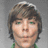 Pixelated image of a person with brown hair and green eyes on a gray background, next to blue background with pink text.