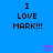 Blue background with black pixelated text reading "I LOVE MARK!!!" and two pink heart symbols at the bottom.