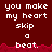 Red background with white pixelated text reading "you make my heart skip a beat." repeated in multiple