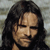Pixelated portrait of a person with long dark hair, neutral expression, and light skin tone against a muted background.