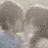 Two pixelated figures in close proximity with indistinct facial features and muted brown, gray, and blue tones.