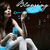 Animated sequence of a woman in blue and white clothing holding a light blue object against dark background with scattered particles.